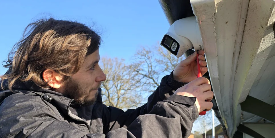 Engineer servicing a security camera